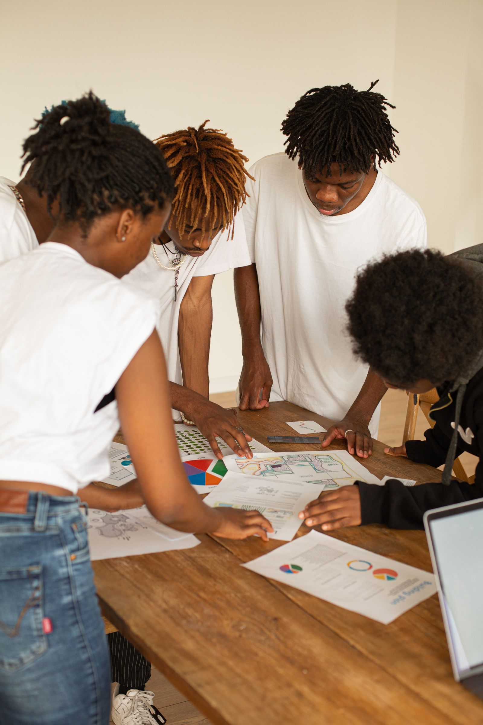 Diverse colleagues brainstorming over charts and graphs